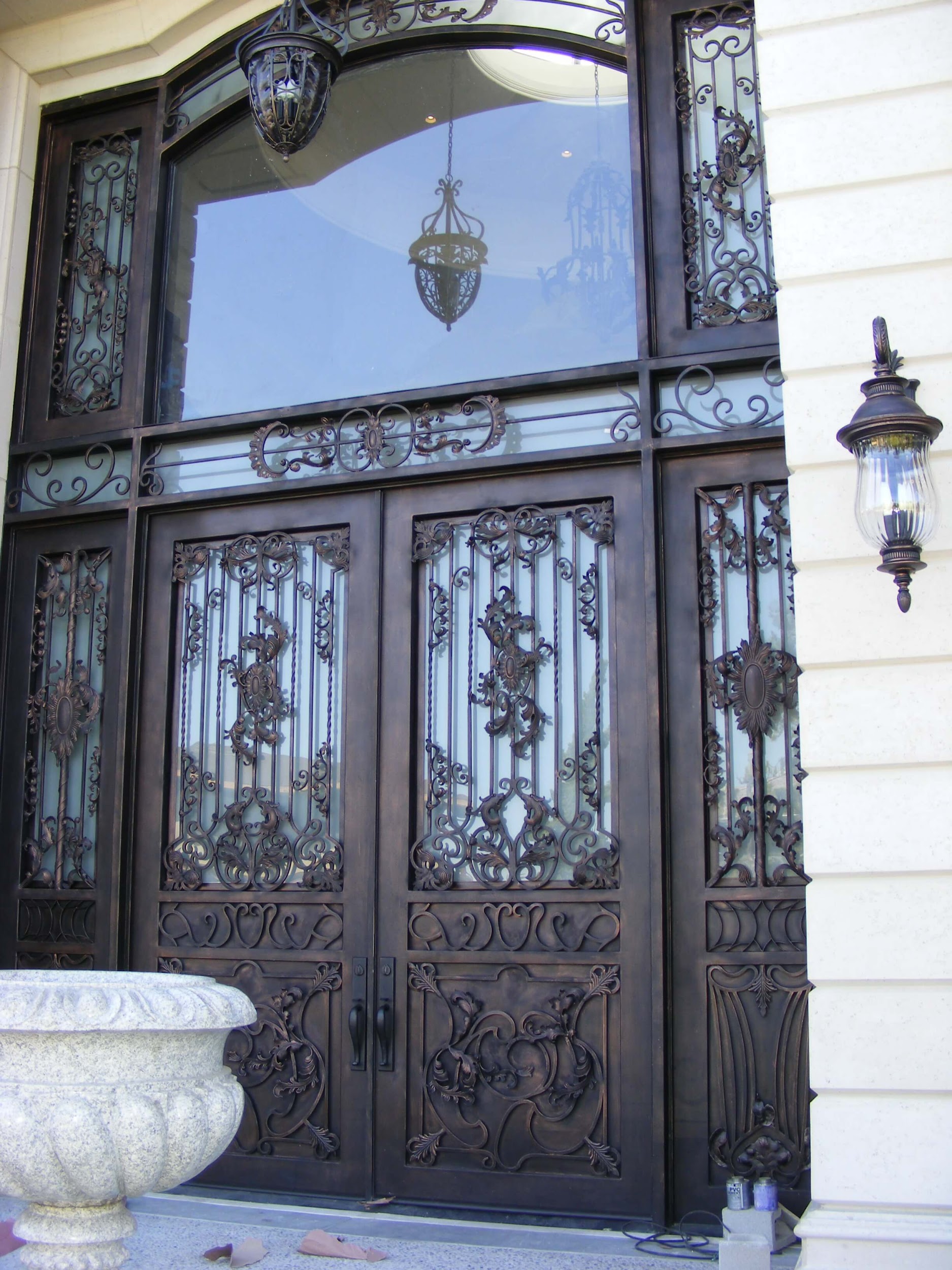 top ornamental iron doors with transom and sidelights