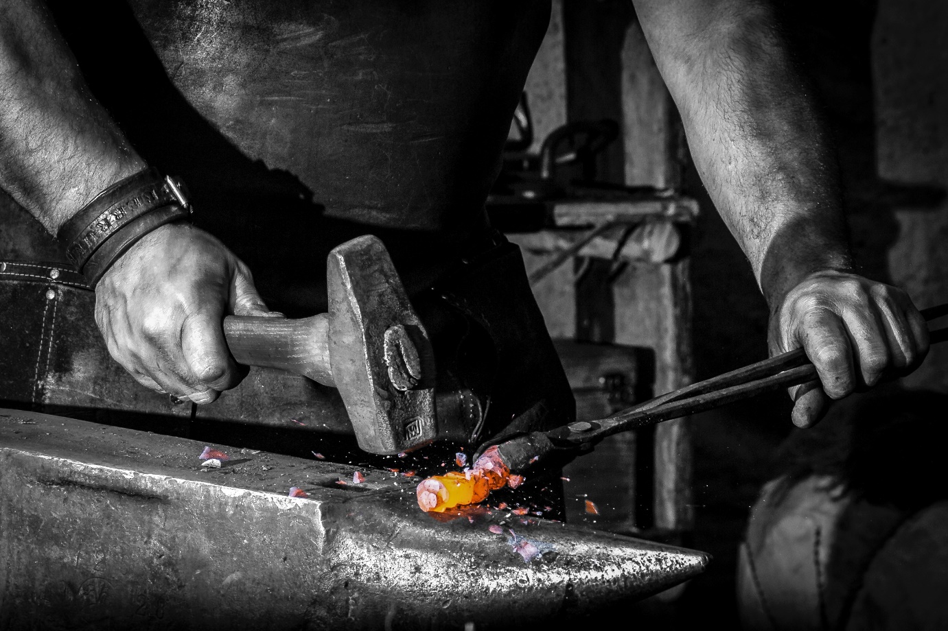 blacksmith working hot metal with a hammer and anvil