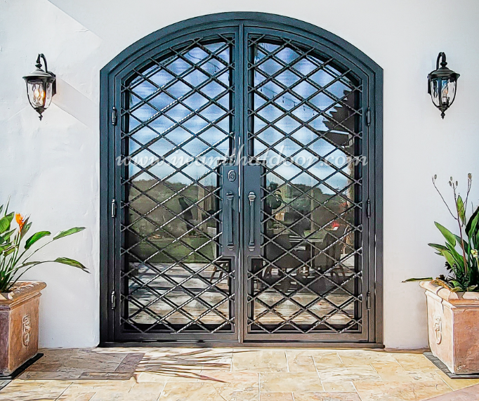 Custom iron French doors from Universal iron doors leading to a beautiful backyard